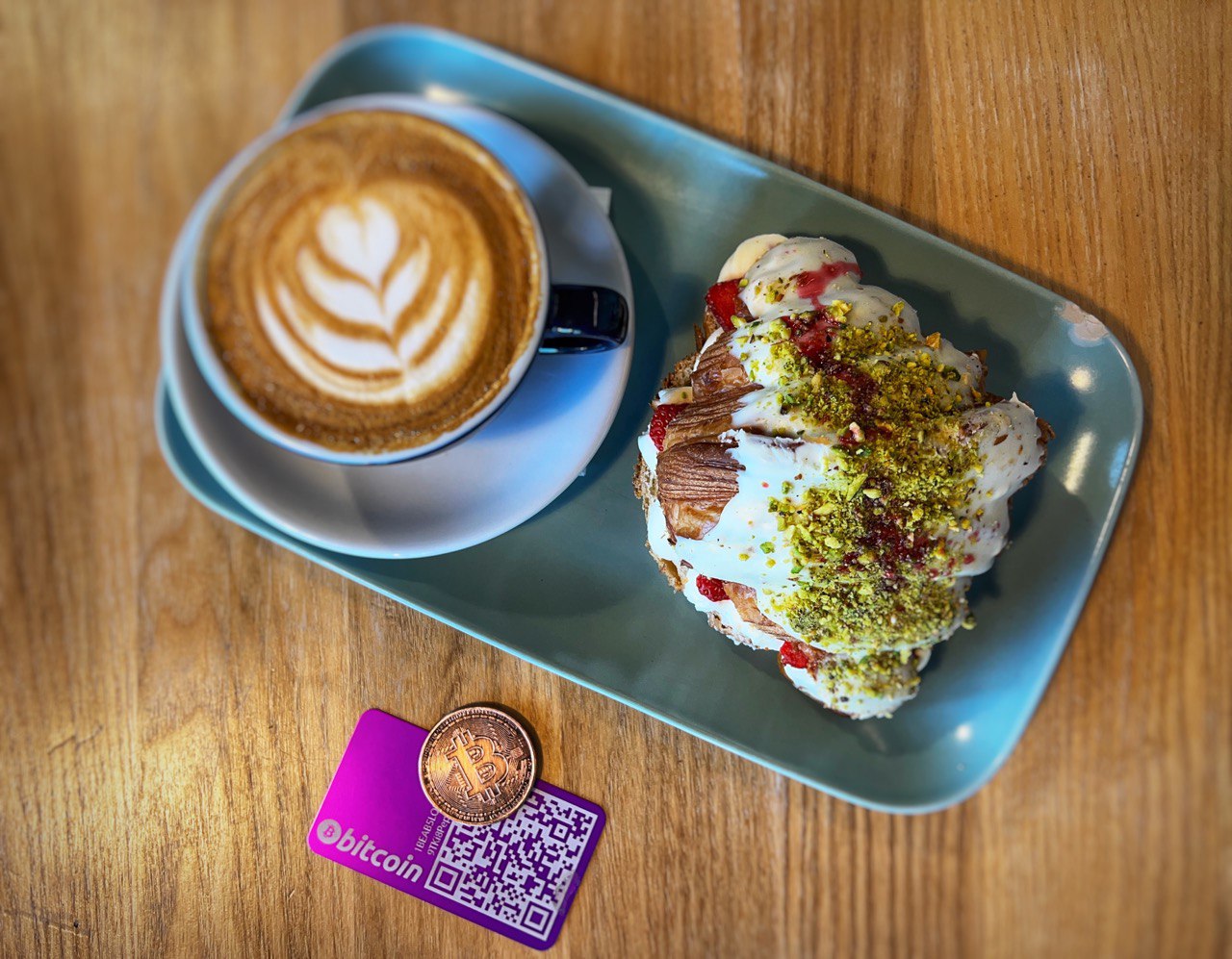Picture: Bitcoin wallet next to a breakfast in a Bitcoin accepting restaurant