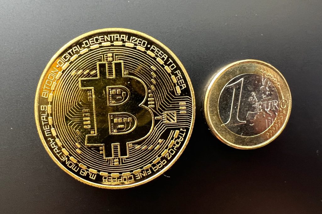 Picture: A Bitcoin sign next to a 1 euro coin